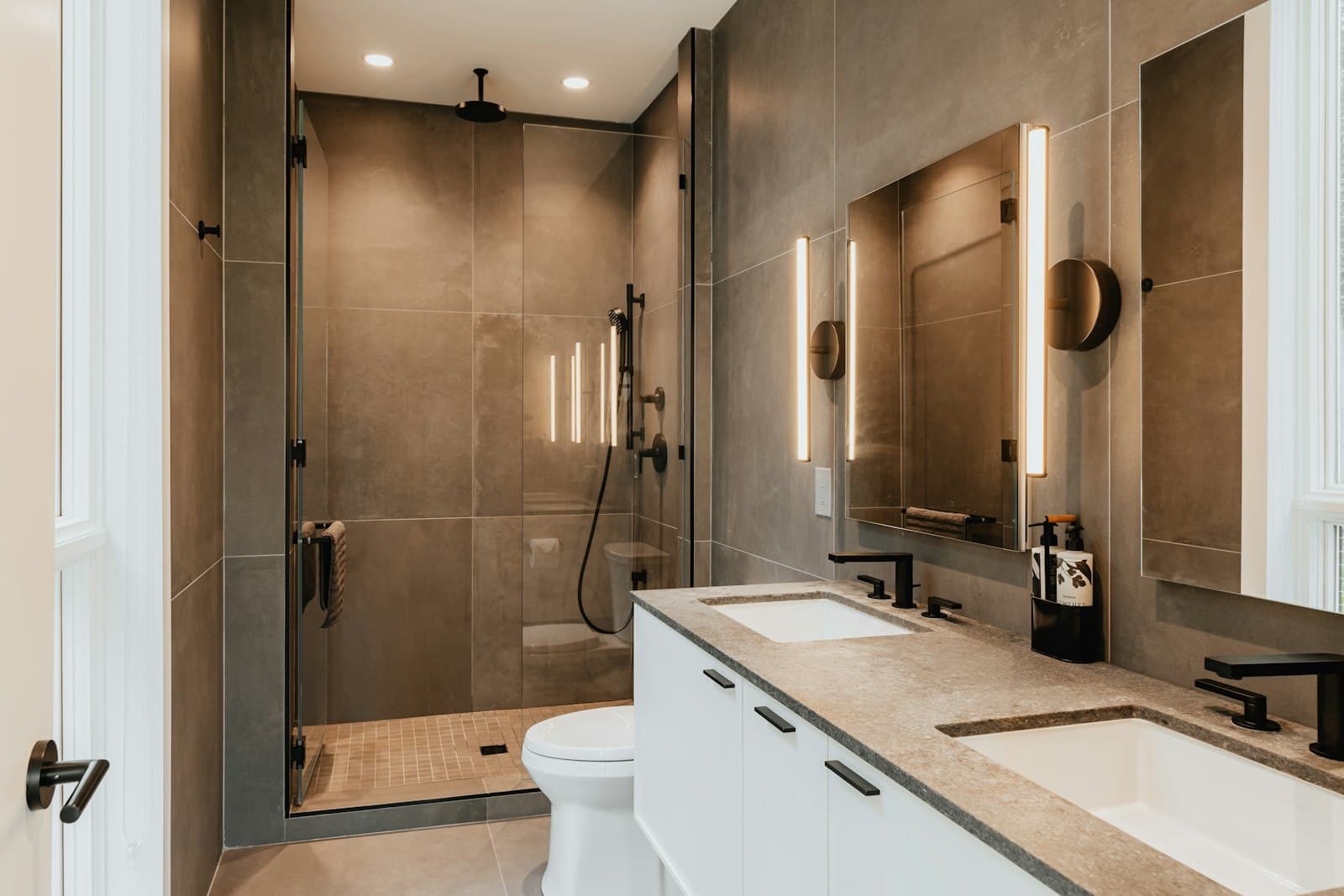 Bathroom with walk-in shower, warm tiles and vanity unit