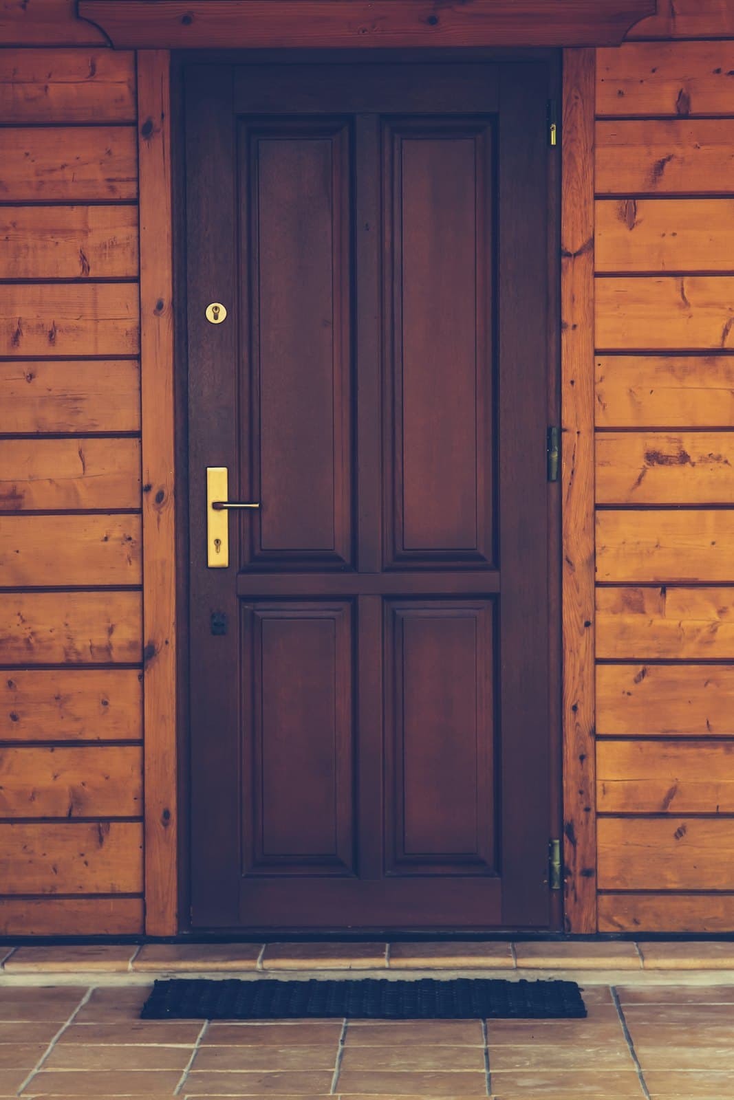 Panelled wooden front door with brass fittings