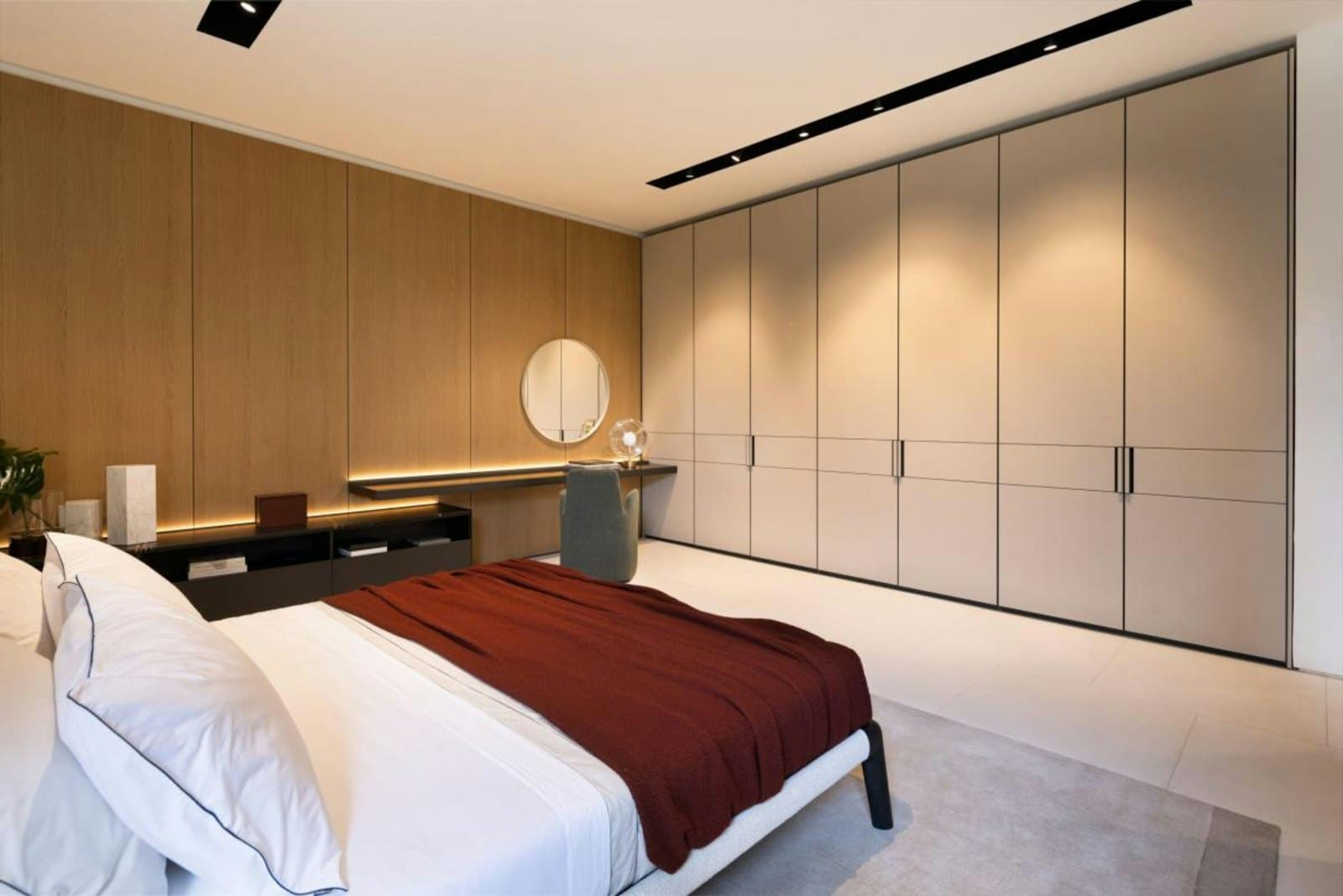 Bedroom with built-in wardrobes and wooden wall panelling