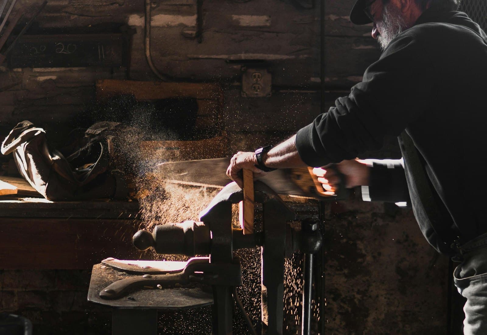 Craftsman sawing wood in a workshop